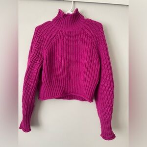 Bright pink turtleneck sweater